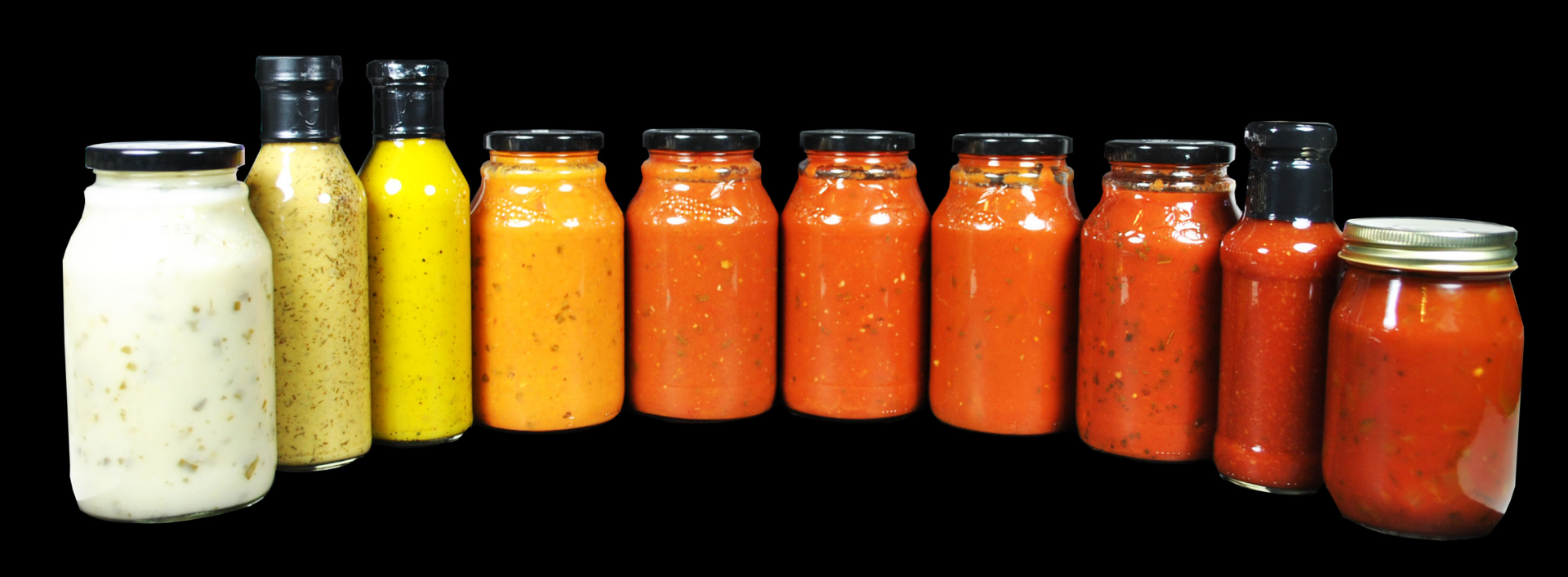 Four jars of different sauces are lined up.